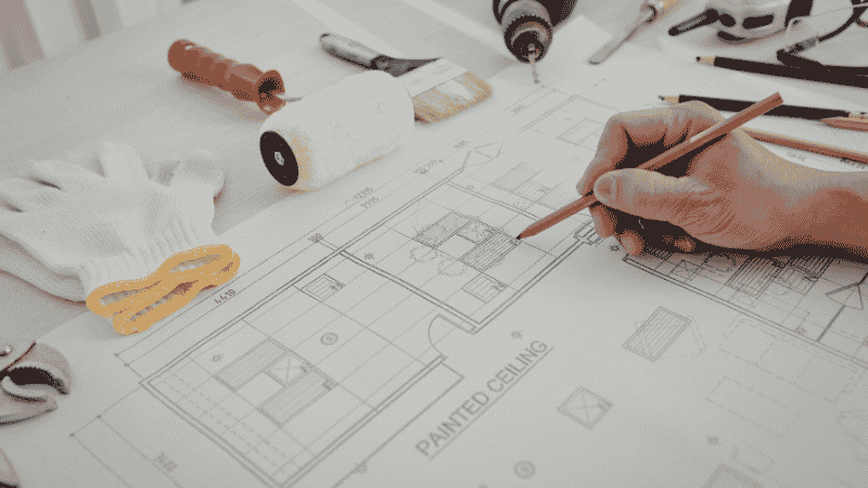 A property developer working on their planning permission documents before submitting to the local authority.